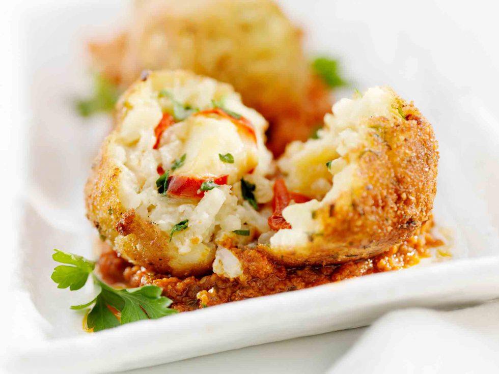 Calgary Food Photography. Breaded crab cakes with garnish.