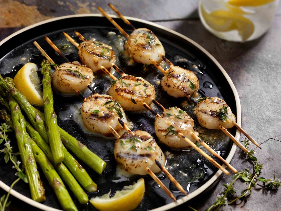 Calgary Food Photography. Buttered up and seasoned scallop skewers with lemon and asparagus.