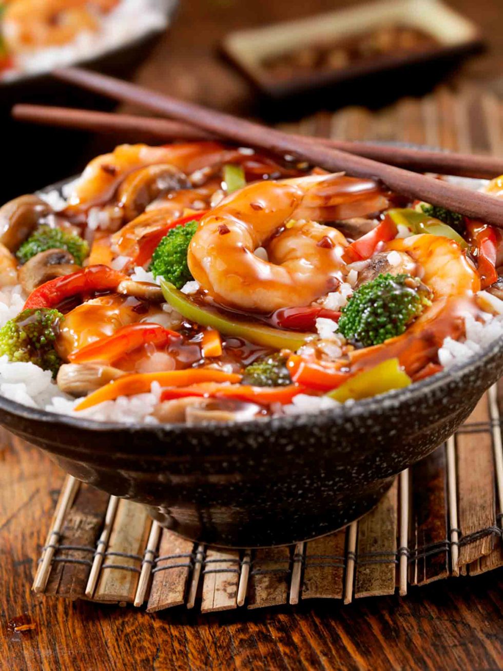 Calgary Food Photography. Close up shot of teriyaki glazed shrimp rice bowl on bamboo mat.