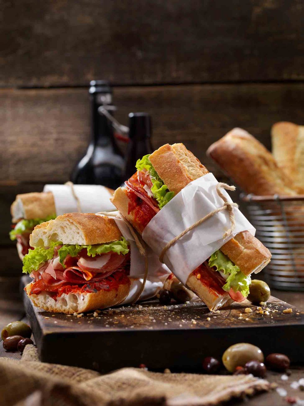 Calgary Food Photography. Fresh wrapped and tied deli sandwiches on rustic backdrop.