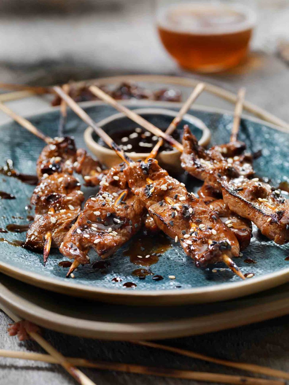 Calgary Food Photography. Korean beef skewers seasoned with sesame on modern rustic plating.