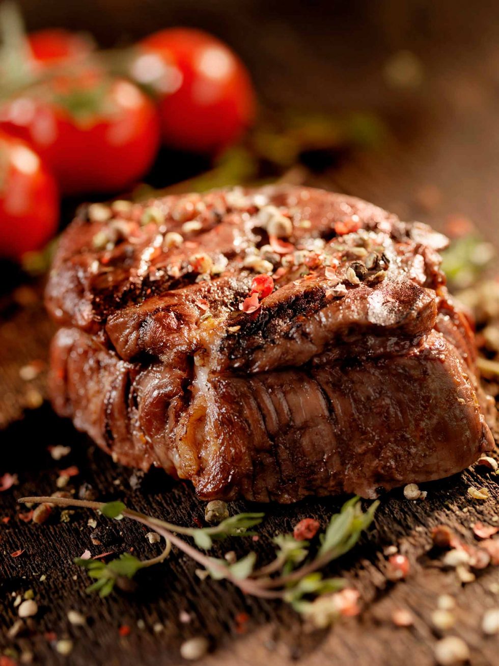 Calgary Food Photography. Perfectly cooked and seasoned steak, garnished on rustic backdrop.