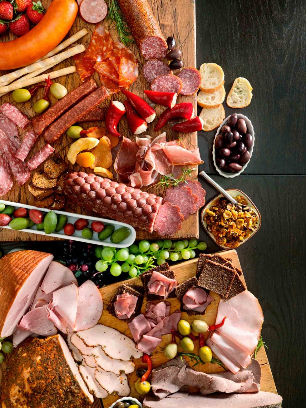Calgary Food Photography. Rustic charcuterie display, assortment of cured meets with olives, breads and more.