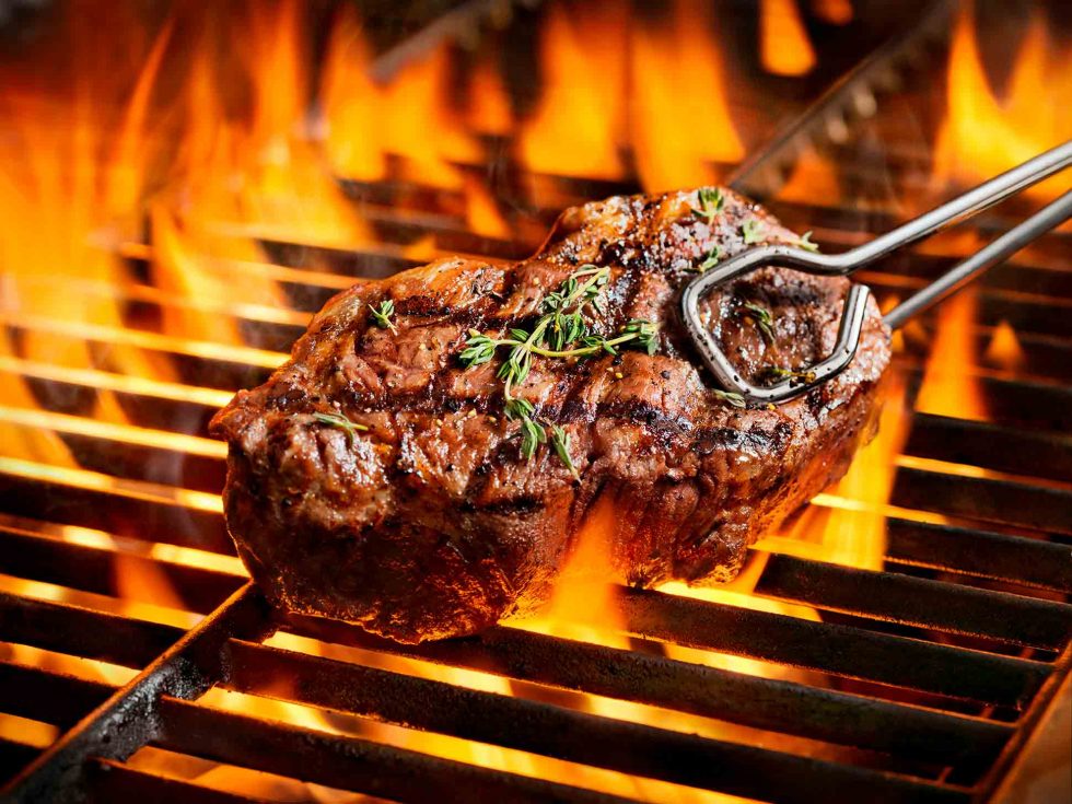 Calgary Food Photography. Seasoned steak on the barbeque with perfect grill marks.