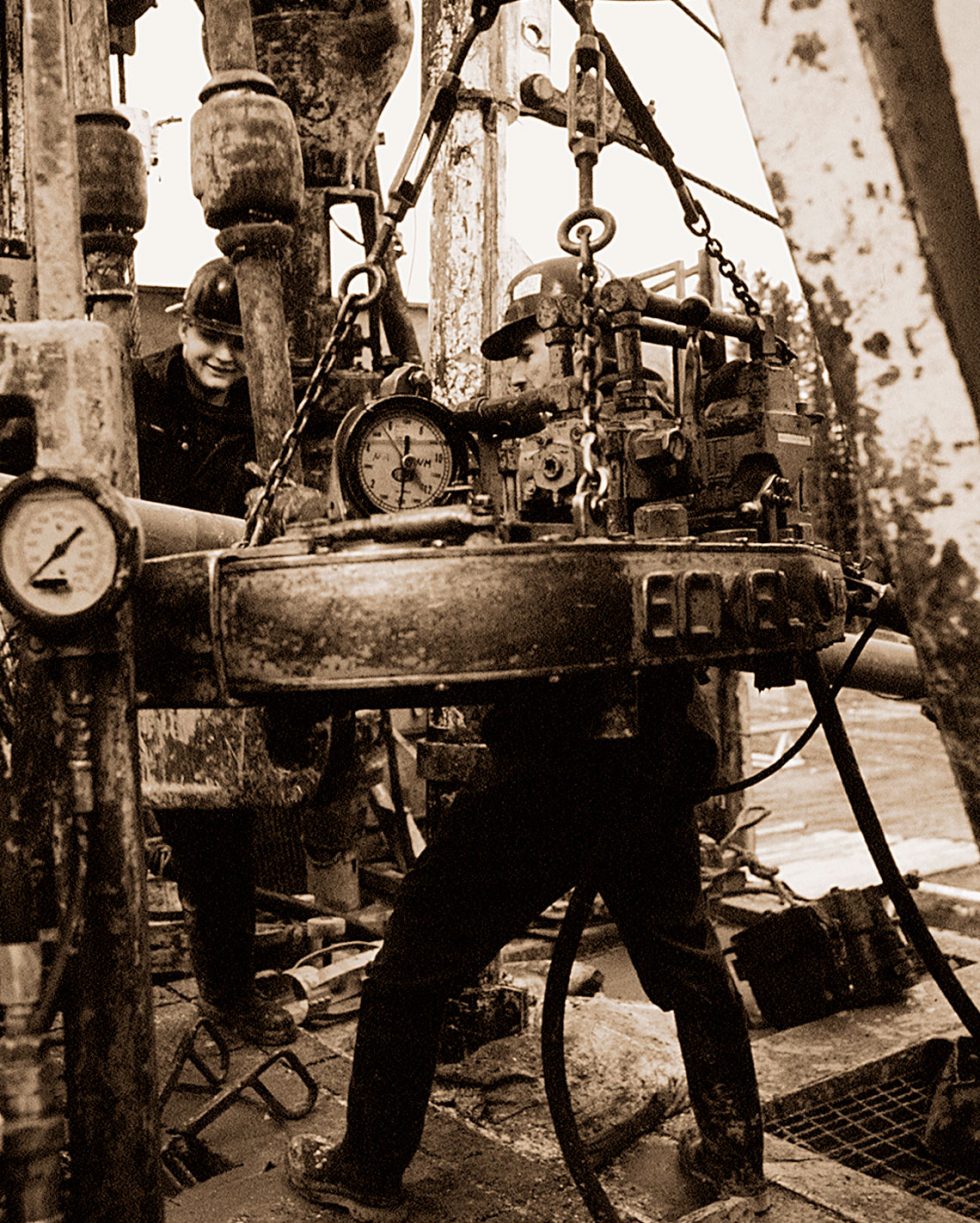 Calgary Onsite Photographer. Black & White sepia photo of men on oil rig.