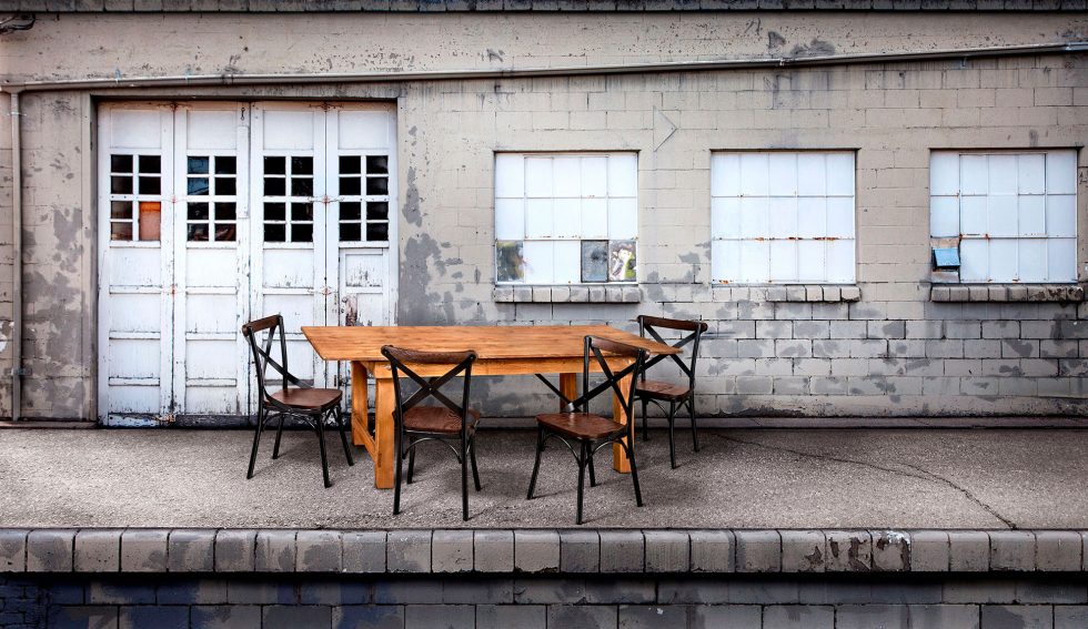 Calgary Onsite Photographer. Rustic dining table and chairs setup outdoors.