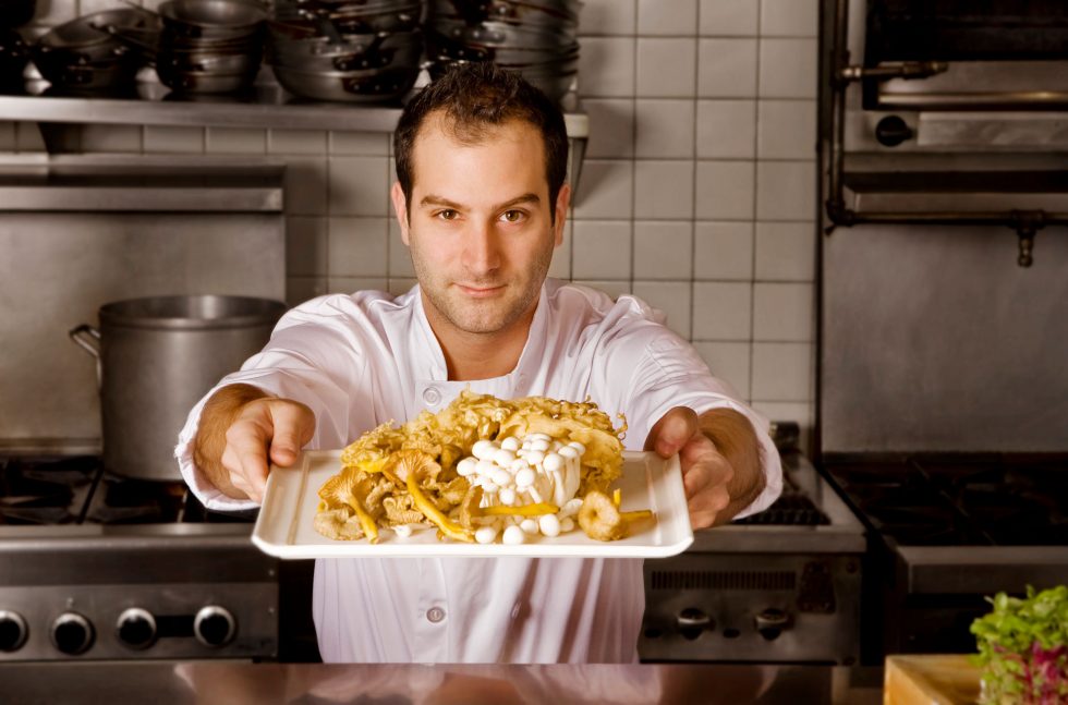 Calgary People Photographer. Chef presenting a plate of mushrooms.