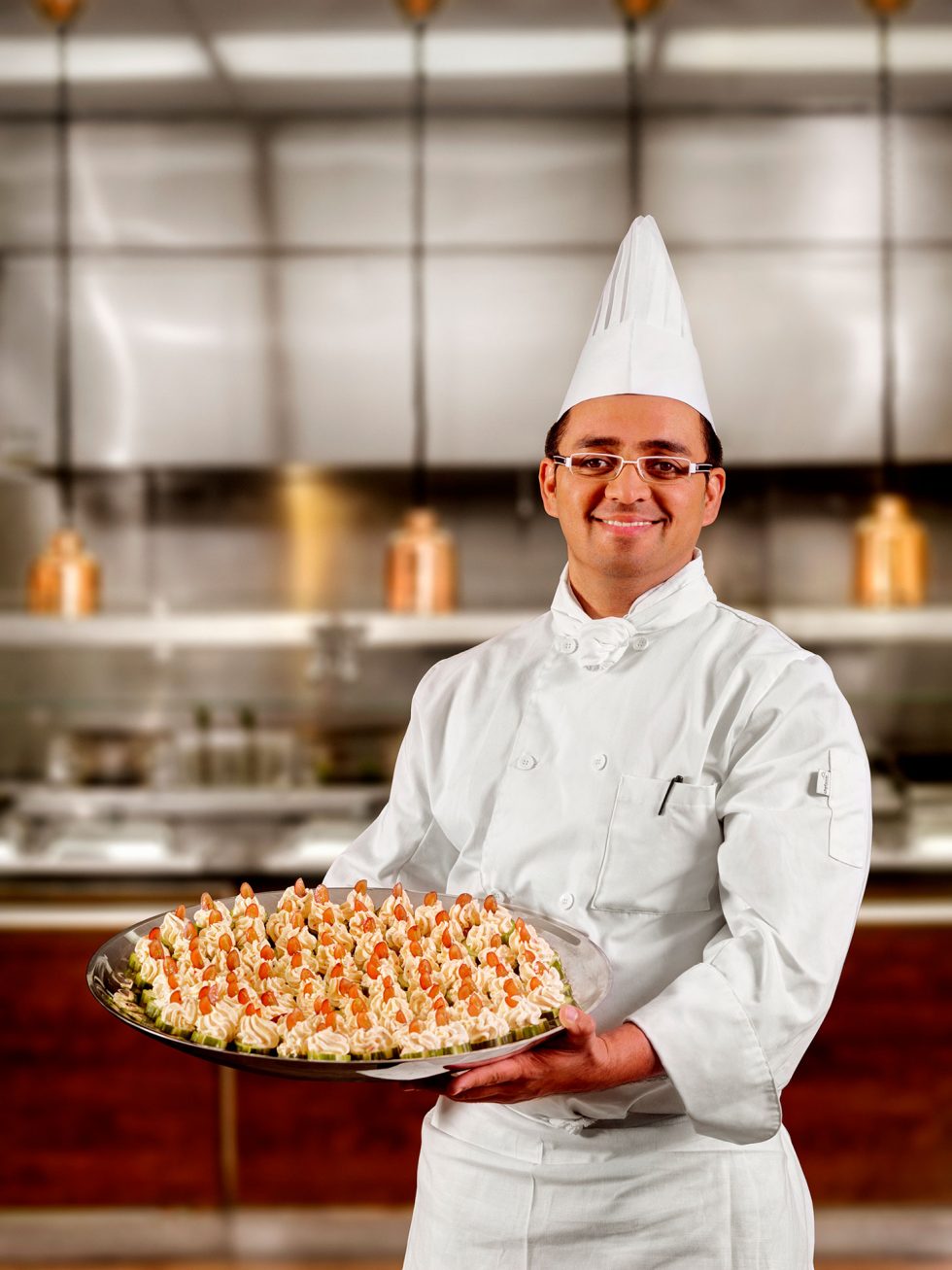 Calgary People Photographer. Chef presenting a platter of desserts.