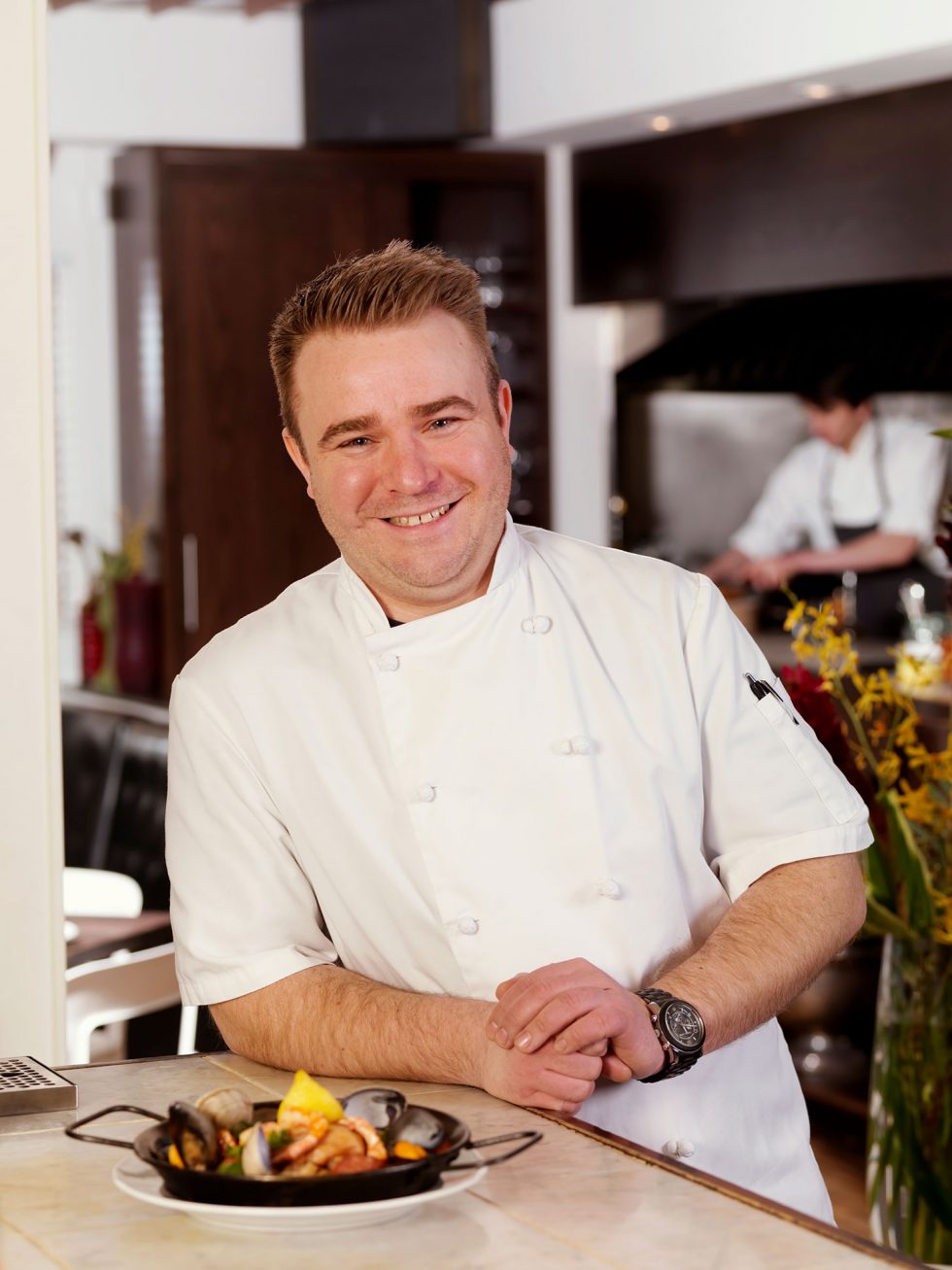 Calgary People Photographer. Chef smiling in kitchen.