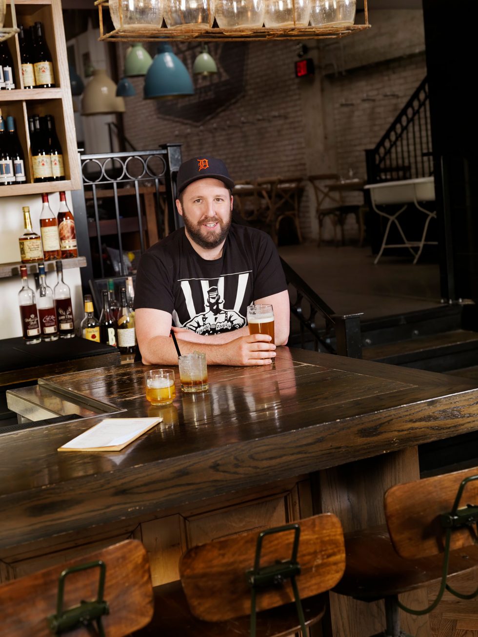 Calgary People Photography. Man sitting at bar with a beer in hand.